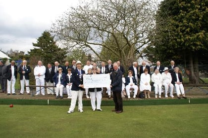 Bowls club hands over £1,572 to dementia charity