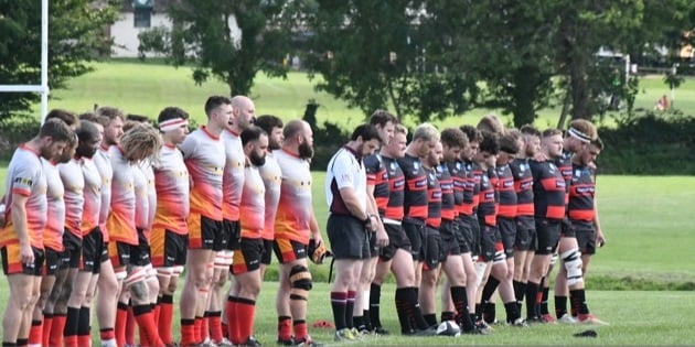 Chard and Wellington rugby players observing minute’s silence for the Queen.