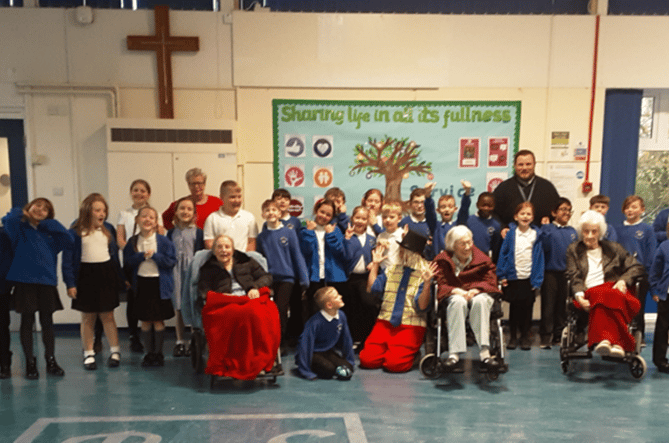 Archie meets Rockwell Green primary School pupils and some elderly residents.