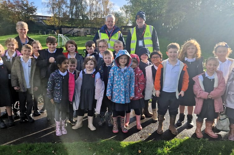 Purple crocus bulbs were planted in the grounds of Isambard Kingdom Brunel School by pupils and Rotary members.