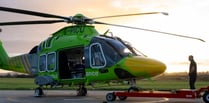 Air ambulance now taking off in green helicopter