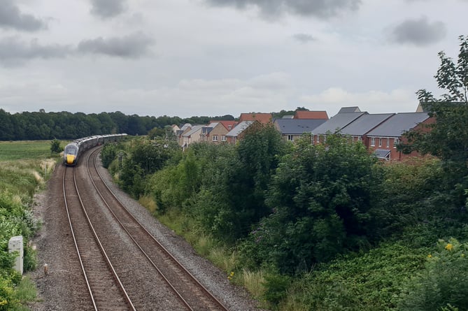 A train passes close to where Wellington Railway Station is planned to be built.