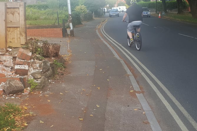 The garden wall destroyed when three cars were involved in a collision in Longforth Road, Wellington, on Saturday night.