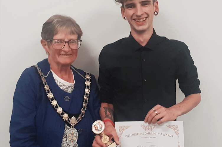 Odette's tea room's Toby Brimacombe receives Wellington Town Council's community business award from Mayor Cllr Janet Lloyd.