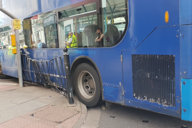 The 22A Wellington to Taunton bus stuck on railings in Wellington town centre.