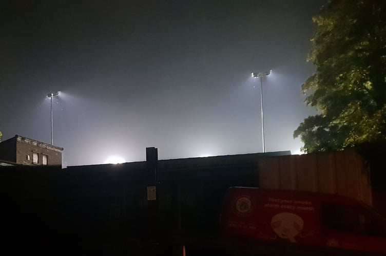 Wellington Football Club's existing floodlights in use for a match, viewed from North Street.