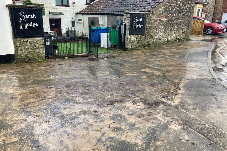 Mud and debris outside Sarah Hodge hair salon in Chard town centre 